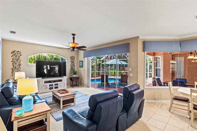 866 Oak Briar Ln, Osprey, FL 34229 - tiled living room with a ceiling fan, baseboards, a textured ceiling, and crown molding