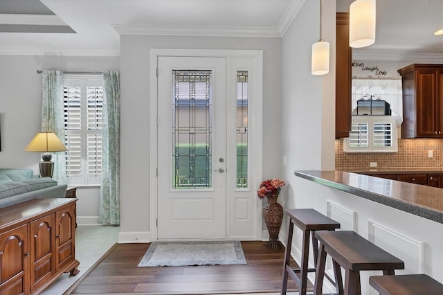 5117 Serata Dr, Bradenton, FL 34211 - foyer with dark wood-style floors, crown molding, and baseboards