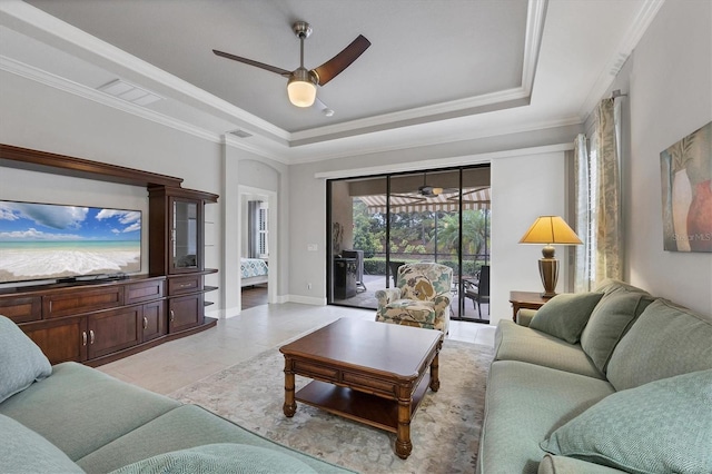 5117 Serata Dr, Bradenton, FL 34211 - living room with ceiling fan, a tray ceiling, crown molding, and baseboards