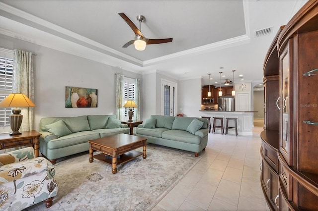 5117 Serata Dr, Bradenton, FL 34211 - living area featuring a raised ceiling, ceiling fan, ornamental molding, and light tile patterned floors