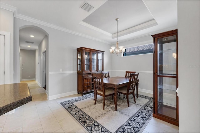 5117 Serata Dr, Bradenton, FL 34211 - dining area featuring arched walkways, a chandelier, light tile patterned floors, crown molding, and baseboards