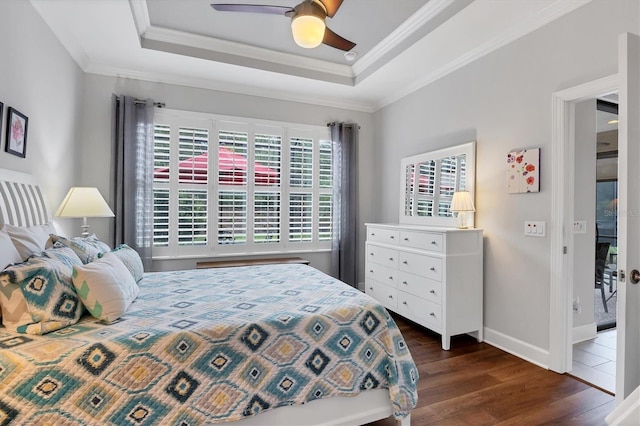 5117 Serata Dr, Bradenton, FL 34211 - bedroom featuring dark wood finished floors, crown molding, baseboards, a tray ceiling, and ceiling fan