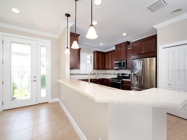 4949 Savona Run, Bradenton, FL 34211 - kitchen with stainless steel appliances, light countertops, light tile patterned floors, a peninsula, and ornamental molding
