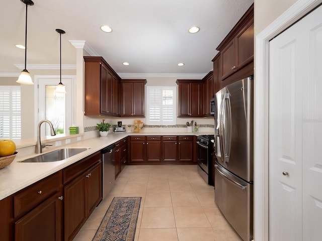 4949 Savona Run, Bradenton, FL 34211 - kitchen featuring stainless steel appliances, crown molding, light tile patterned floors, light countertops, and pendant lighting