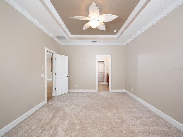 4949 Savona Run, Bradenton, FL 34211 - unfurnished bedroom featuring a tray ceiling, crown molding, light carpet, and a ceiling fan
