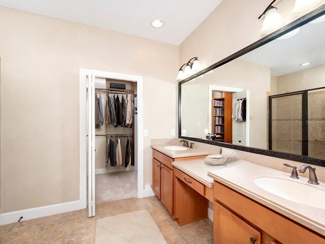 4949 Savona Run, Bradenton, FL 34211 - bathroom with a walk in closet, double vanity, a stall shower, tile patterned floors, and recessed lighting