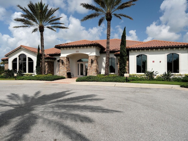 4949 Savona Run, Bradenton, FL 34211 - mediterranean / spanish-style house with french doors, stucco siding, a tile roof, and stone siding