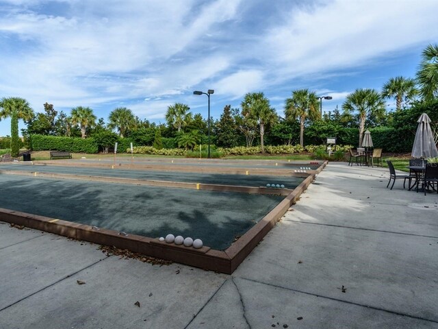 4949 Savona Run, Bradenton, FL 34211 - view of community featuring a bocce ball area and view of wooded area
