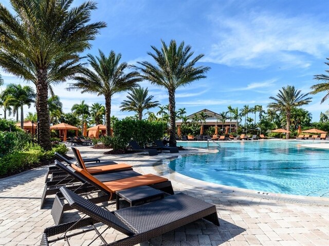 4949 Savona Run, Bradenton, FL 34211 - community pool featuring a patio area