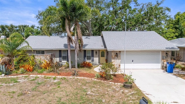 2204 67th St W, Bradenton, FL 34209 - view of front of property with a garage, concrete driveway, stone siding, stucco siding, and a shingled roof