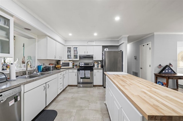 2204 67th St W, Bradenton, FL 34209 - kitchen with appliances with stainless steel finishes, wood counters, under cabinet range hood, a sink, and ornamental molding