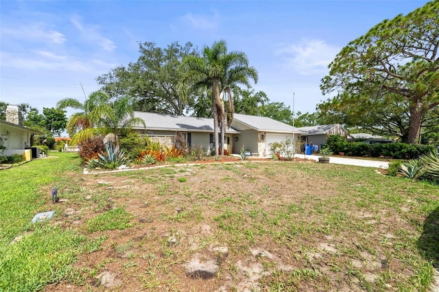 2204 67th St W, Bradenton, FL 34209 - view of front of home with a garage, concrete driveway, and a front lawn