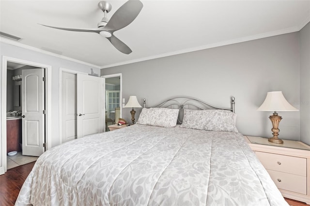 2204 67th St W, Bradenton, FL 34209 - bedroom with dark wood finished floors, ornamental molding, connected bathroom, and ceiling fan