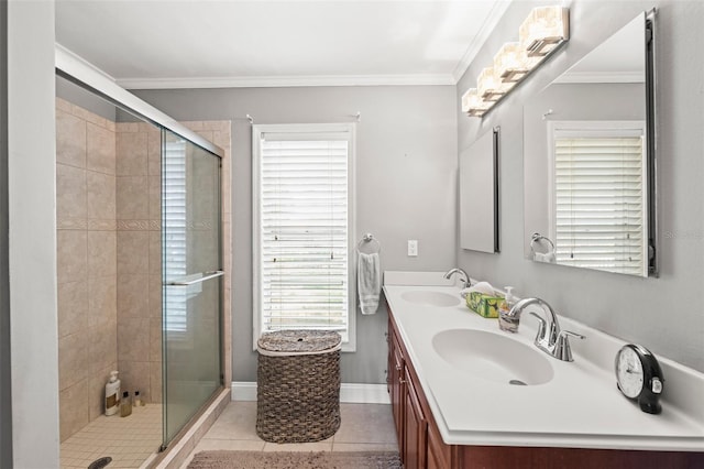2204 67th St W, Bradenton, FL 34209 - bathroom featuring double vanity, a stall shower, tile patterned floors, ornamental molding, and baseboards