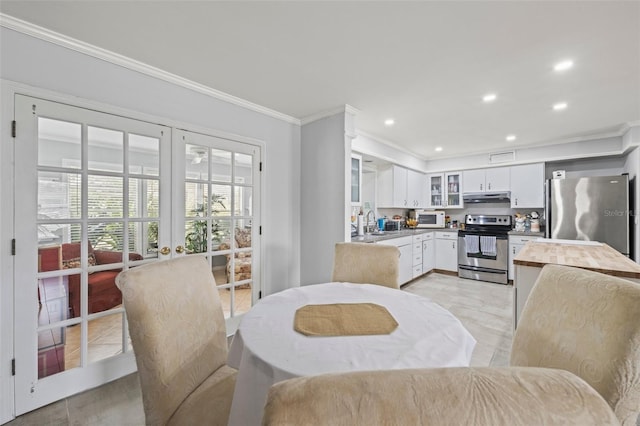 2204 67th St W, Bradenton, FL 34209 - dining area featuring ornamental molding, french doors, recessed lighting, and light wood-type flooring