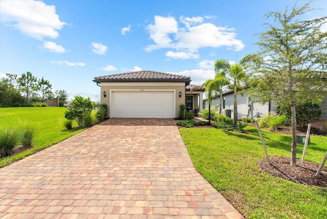 6791 Alstead Cir, Bradenton, FL 34202 - mediterranean / spanish home featuring decorative driveway, stucco siding, a front lawn, an attached garage, and a tile roof