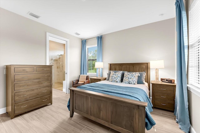 6791 Alstead Cir, Bradenton, FL 34202 - bedroom with wood tiled floors and ensuite bath