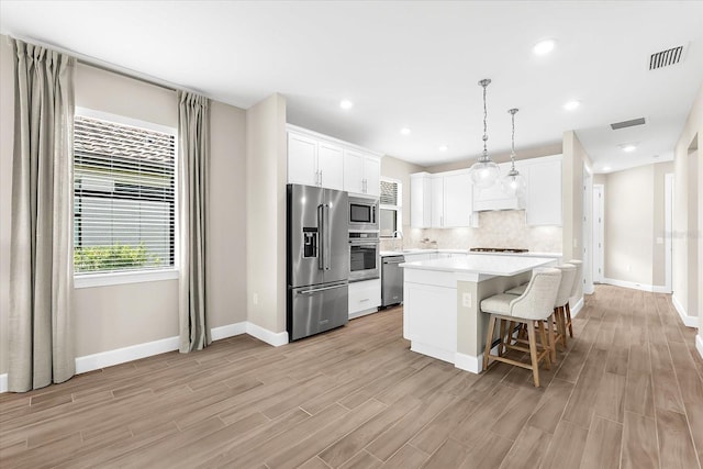 6791 Alstead Cir, Bradenton, FL 34202 - kitchen featuring stainless steel appliances, backsplash, light wood-style floors, light countertops, and recessed lighting
