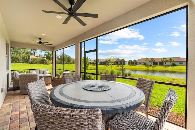 6791 Alstead Cir, Bradenton, FL 34202 - sunroom featuring a ceiling fan, a water view, a residential view, and outdoor dining space