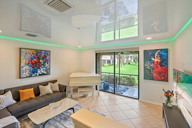 7325 Skybird Rd Unit 399, Bradenton, FL 34209 - living area featuring light tile patterned flooring, a towering ceiling, baseboards, and recessed lighting