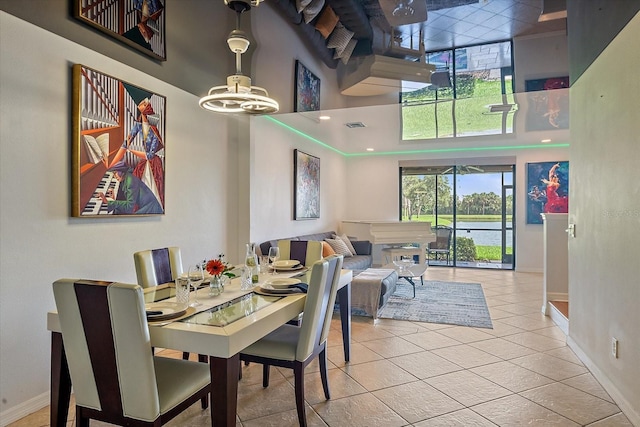 7325 Skybird Rd Unit 399, Bradenton, FL 34209 - dining room with a high ceiling, baseboards, light tile patterned floors, and a chandelier