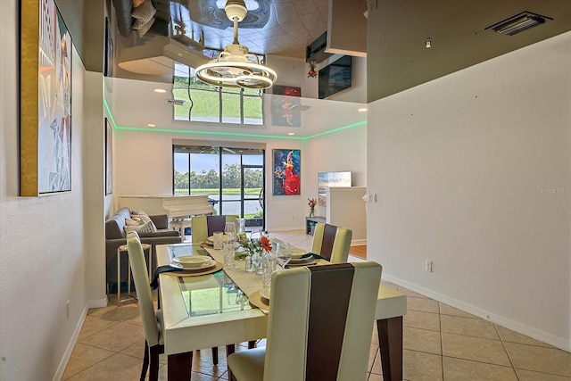7325 Skybird Rd Unit 399, Bradenton, FL 34209 - dining area with tile patterned floors, baseboards, and a towering ceiling
