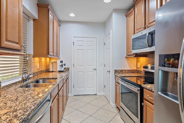 7325 Skybird Rd Unit 399, Bradenton, FL 34209 - kitchen featuring stainless steel appliances, light tile patterned floors, stone countertops, tasteful backsplash, and recessed lighting