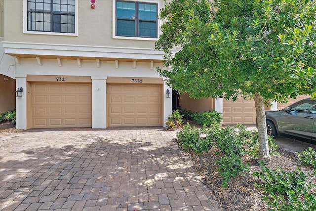 7325 Skybird Rd Unit 399, Bradenton, FL 34209 - multi unit property featuring stucco siding, decorative driveway, and an attached garage