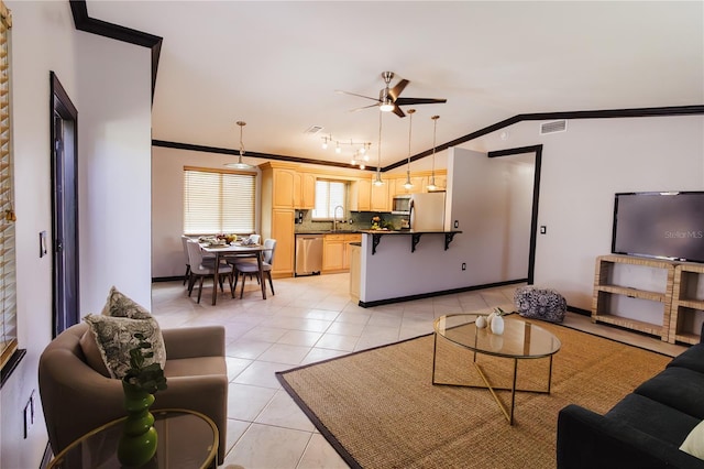 4945 Camphor Ave, Sarasota, FL 34231 - living room featuring ceiling fan, crown molding, light tile patterned floors, and lofted ceiling