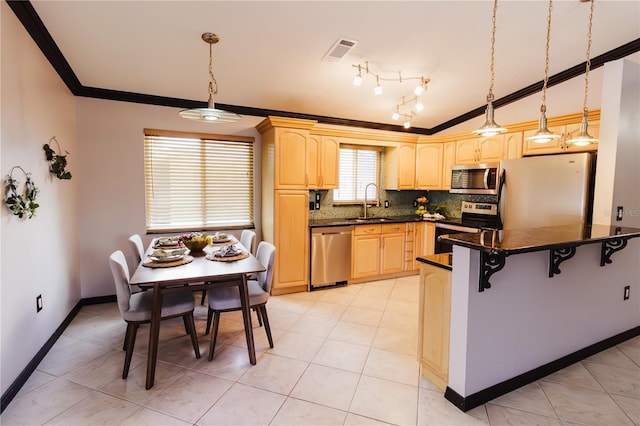 4945 Camphor Ave, Sarasota, FL 34231 - kitchen with appliances with stainless steel finishes, ornamental molding, dark countertops, light brown cabinetry, and a breakfast bar area