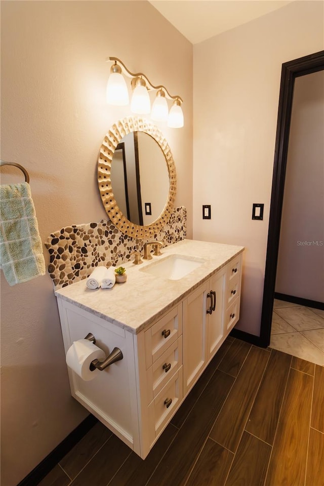 4945 Camphor Ave, Sarasota, FL 34231 - bathroom featuring vanity, wood finished floors, and tasteful backsplash