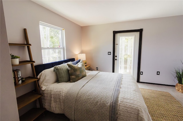 4945 Camphor Ave, Sarasota, FL 34231 - bedroom with light tile patterned floors and access to exterior