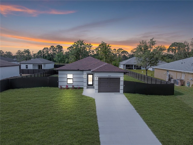 920 Barton St E, Lehigh Acres, FL 33974 - view of front facade with an attached garage, concrete driveway, and a shingled roof