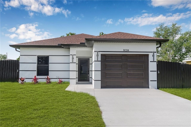 920 Barton St E, Lehigh Acres, FL 33974 - view of front of property with driveway, an attached garage, stucco siding, and roof with shingles
