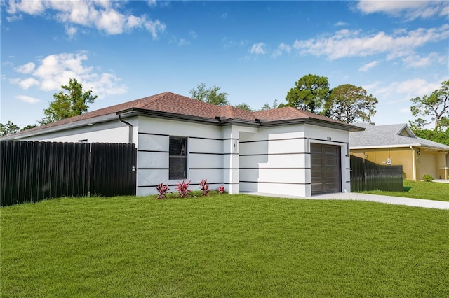 920 Barton St E, Lehigh Acres, FL 33974 - view of front of home featuring stucco siding, a garage, and driveway