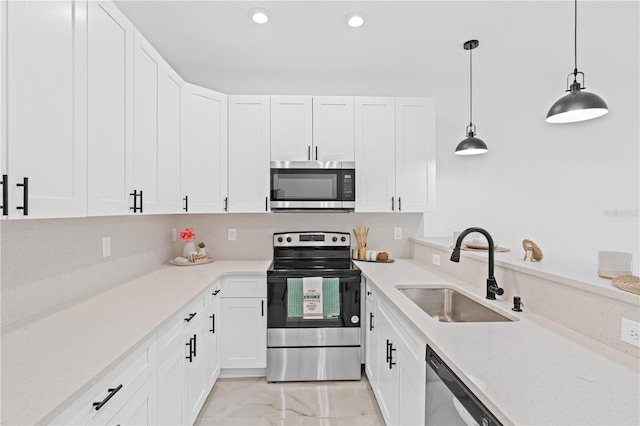 920 Barton St E, Lehigh Acres, FL 33974 - kitchen with stainless steel appliances, a sink, light countertops, and recessed lighting