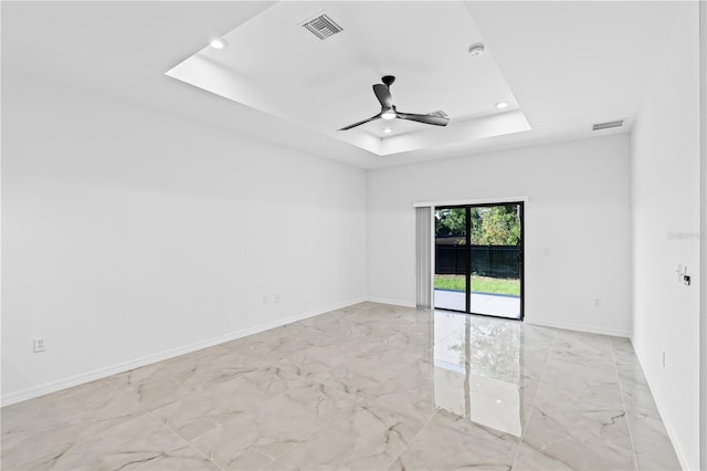 920 Barton St E, Lehigh Acres, FL 33974 - unfurnished room featuring light marble finish flooring, ceiling fan, recessed lighting, a tray ceiling, and baseboards