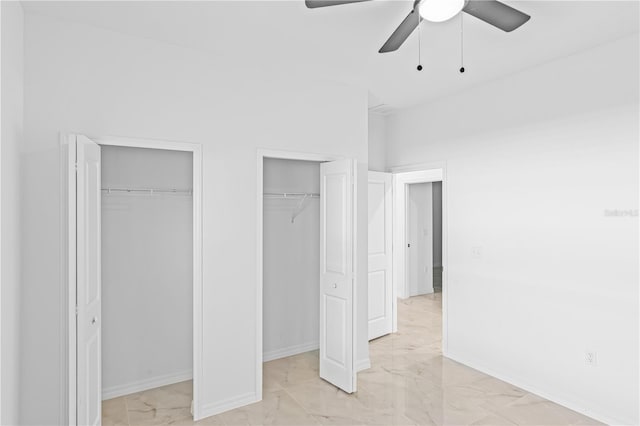 920 Barton St E, Lehigh Acres, FL 33974 - unfurnished bedroom featuring two closets, light marble finish floors, ceiling fan, and baseboards