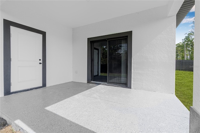 920 Barton St E, Lehigh Acres, FL 33974 - entrance to property with stucco siding and a patio
