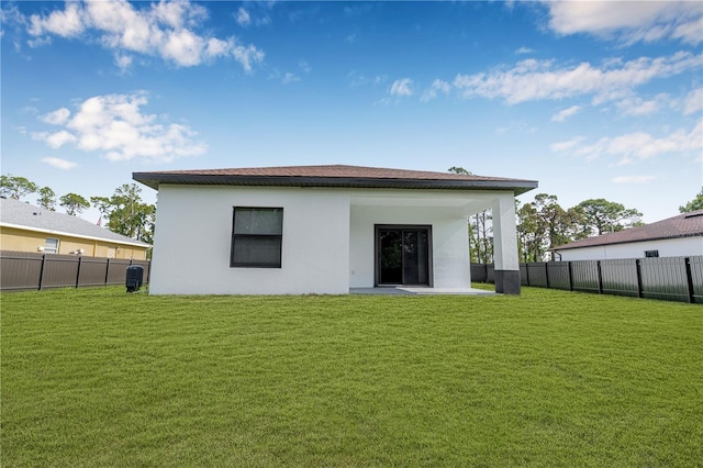 920 Barton St E, Lehigh Acres, FL 33974 - back of house with stucco siding and a patio area