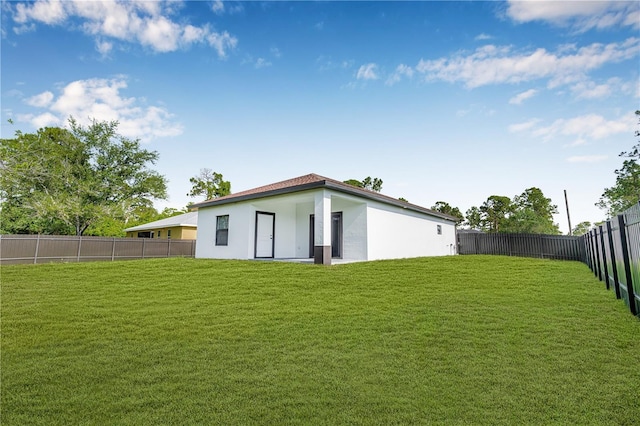 920 Barton St E, Lehigh Acres, FL 33974 - rear view of property with stucco siding