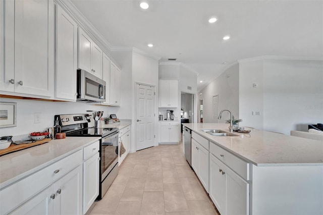 5695 Palmer Cir Unit 203, Bradenton, FL 34211 - kitchen with stainless steel appliances, crown molding, recessed lighting, a kitchen island with sink, and white cabinets