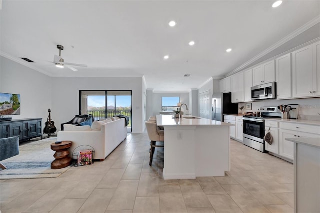 5695 Palmer Cir Unit 203, Bradenton, FL 34211 - kitchen with stainless steel appliances, ornamental molding, open floor plan, a ceiling fan, and recessed lighting