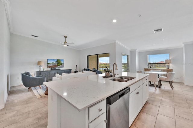 5695 Palmer Cir Unit 203, Bradenton, FL 34211 - kitchen with stainless steel dishwasher, white cabinets, crown molding, a center island with sink, and light stone counters