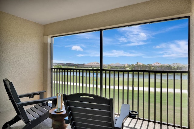 5695 Palmer Cir Unit 203, Bradenton, FL 34211 - sunroom with healthy amount of natural light and a water view