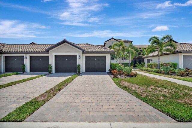 5695 Palmer Cir Unit 203, Bradenton, FL 34211 - view of front of home featuring stucco siding and a tiled roof