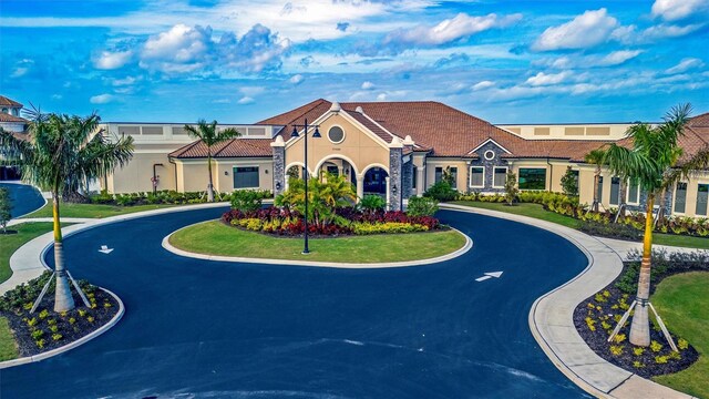 5695 Palmer Cir Unit 203, Bradenton, FL 34211 - view of front of home with curved driveway and stucco siding