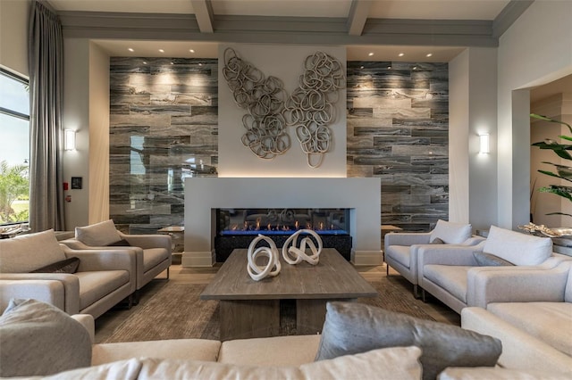 5695 Palmer Cir Unit 203, Bradenton, FL 34211 - living room featuring a glass covered fireplace, beamed ceiling, wood finished floors, and recessed lighting