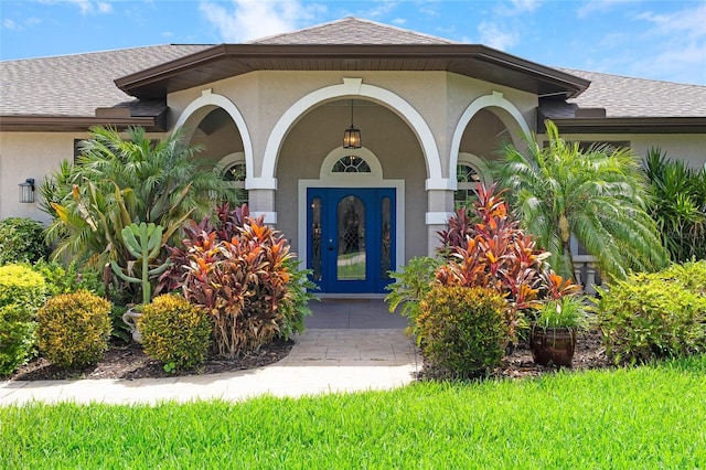 1711 145th St E, Sarasota, FL 34212 - property entrance with stucco siding, roof with shingles, and covered porch