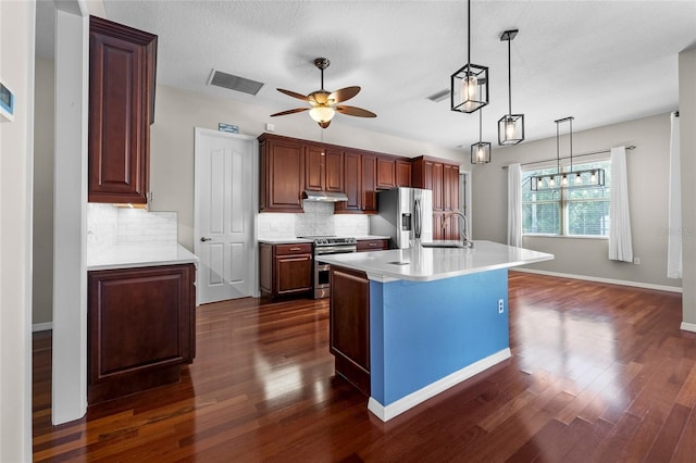 1711 145th St E, Sarasota, FL 34212 - kitchen with appliances with stainless steel finishes, dark wood-style floors, a ceiling fan, decorative backsplash, and light countertops